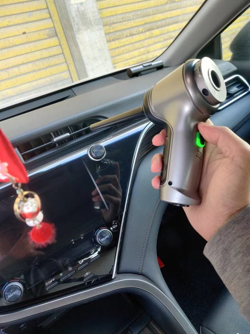 A customer showing off his wireless car vacuum - VacuMax in his car.